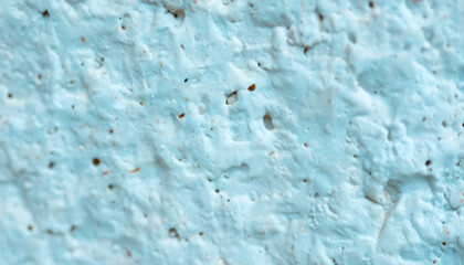 Macro Close-up of Rough Stucco Texture Painted in Pale Cyan Blue. Abstract Bumpy Wall Surface Background Pattern. © Adrian Syauqi