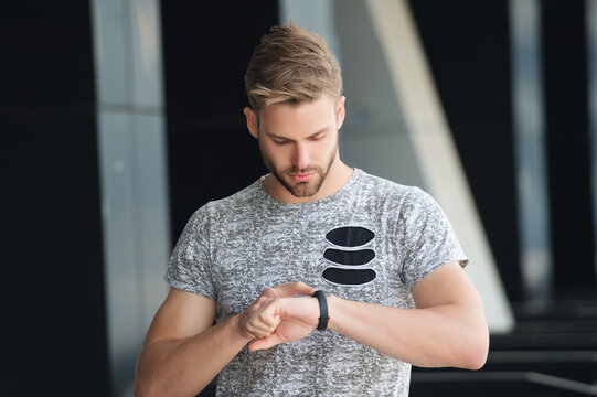 Runner with smartwatch to check pulse. Man measuring heart rate after running. Pulse check. Man check pulse after running outdoor. Man checking heart rate. Wellness and health