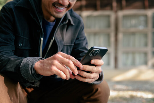 man using mobile phone holding cell phone texting message contact us.chatting,search internet shopping online.device communication connecting