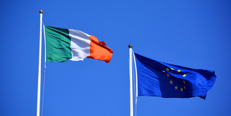 Flag of Europe, Against the blue sky of the Western world, the stars symbolise the peoples of Europe in a form of a circle, a sign of union and The national flag of Ireland © Daniel Meunier