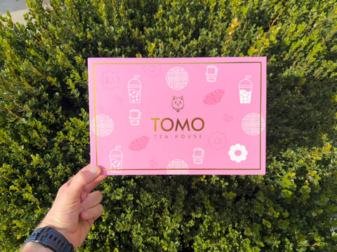 Tomo Tea House Mochi Donuts Pink Gift Box Held Outdoors