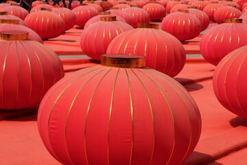 Vibrant red Chinese lanterns with gold trim displayed in a festive outdoor setting