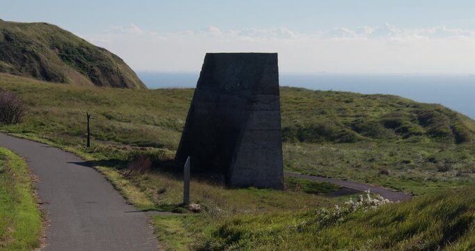 White chart looking onto Abbots Cliff sound mirror with English Channel in background