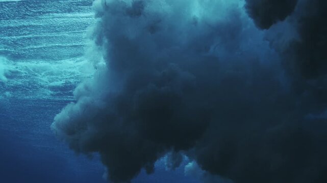 Dark underwater wave turbulence with dense bubbles and moody blue ocean atmosphere