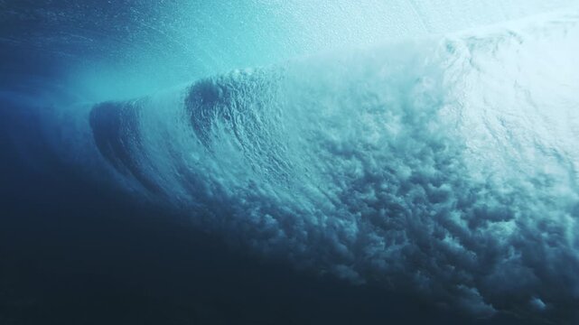 Curving underwater wave wall glowing turquoise with smooth flowing ocean texture