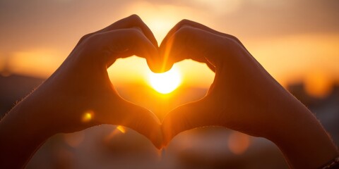 Hands Forming Heart Shape Against Sunset Background with Bright Rays of Light Creating a Warm and Loving Atmosphere