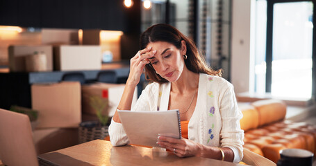 Worry, woman and reading document at new house for property purchase, agreement and hidden fees....