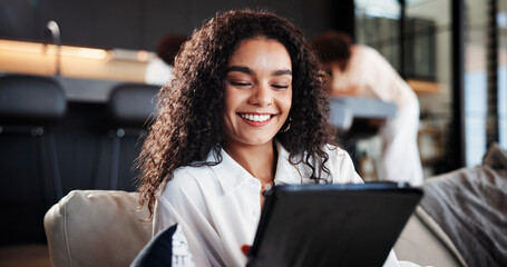 Woman, happy and relax on sofa with tablet at home for funny video, meme and streaming on break in...