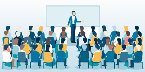 A presenter stands before a large audience in a conference setting © RanjanKumar