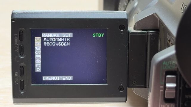 An enthusiast navigates the settings menu on a vintage camcorder screen. Each mode selection triggers a melodic and tinkling electronic chime. This sound confirms every precise digital adjustment.
