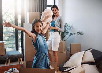 Obraz premium Box, moving and mother with daughter in new home for relocation, bonding and rental property. Love, homeowner and unpacking with woman and child in family house for unboxing, help and connection