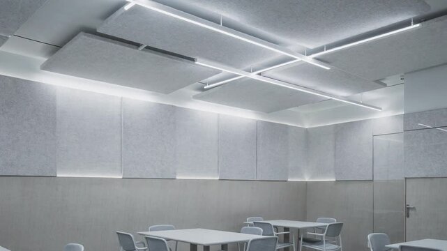 Focused medium shot showcasing bright cool white ceiling fixtures illuminating textured sound panels promoting an energetic and soundcontrolled dining atmosphere.