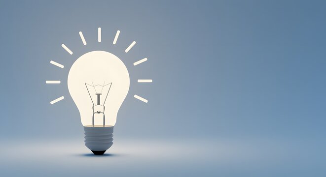 A glowing incandescent light bulb emitting bright light rays in a conceptual representation of ideas and innovation