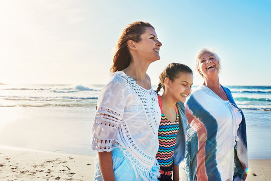 Grandmother, mom and girl on beach and walking for summer holiday, vacation and bonding. Family, generations and women on weekend with mother, child and happy by ocean for love, travel and space
