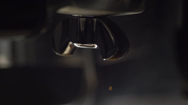 Slow motion macro shot of espresso dripping from a polished portafilter, highlighting rich crema, deep color, and refined texture. Cinematic lighting and dark tones create an exclusive visual for prem