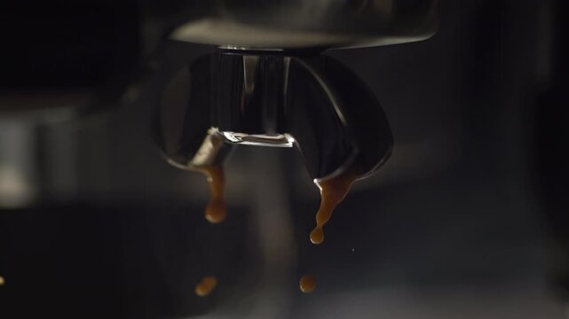 Slow motion close up of espresso flowing from a portafilter with heavy crema formation. Dense golden crema and smooth extraction streams highlight pressure, freshness, and rich coffee texture in moody