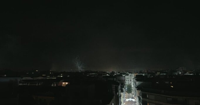 Close-up fireworks captured with a telephoto lens from short distance. Colorful explosions illuminating the night sky during the festive celebration of fallas in Valencia (nit del foc).