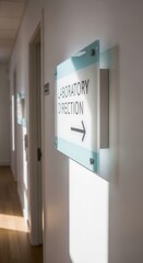 Laboratory Direction Signage Illuminated on White Wall, Guiding Path in Modern Corridor