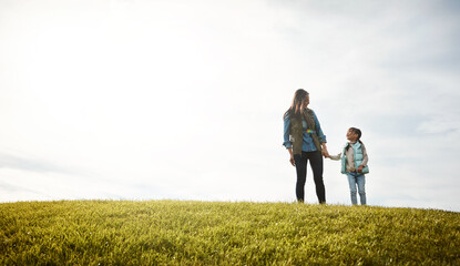 Asian mother, kid and holding hands at park, love and bonding together with parent on holiday. Mom, girl and support in nature with daughter for connection, smile and space on grass field on vacation