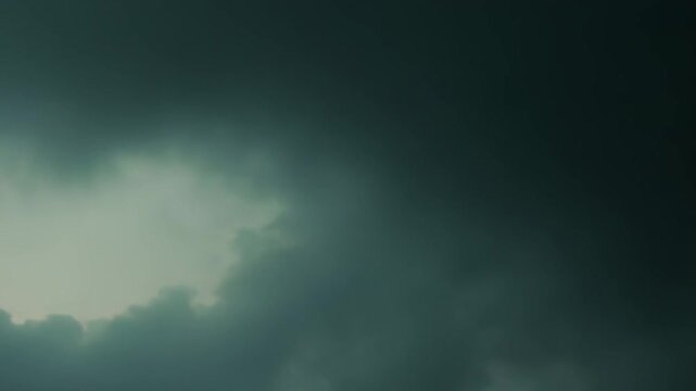 Dark, dense clouds are gathering, creating a moody and dramatic atmosphere with a green tint across the ominous overcast sky, suggesting impending weather changes