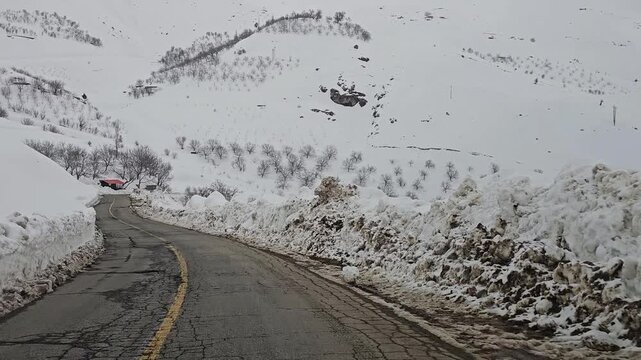 A snow-lined mountain road winding through snowy hills, rugged peaks, and distant tree lines under a cold, overcast winter sky.
📍Hawraman Takht, Kurdistan 