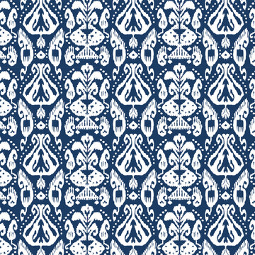 Seamless navy and white ikat damask pattern for textile and wallpaper.