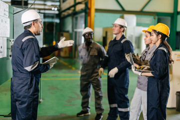 Professional senior lead supervisor engineer man training young engineer team in industry factory
