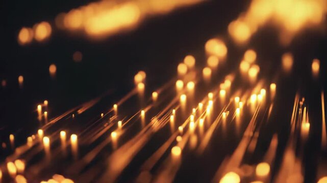 Golden light threads and abstract bokeh particles illuminating a dark surface, creating a dynamic visual of flowing digital data and modern technology connecting concepts
