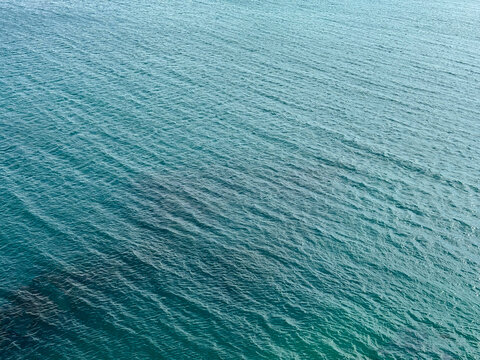 Blue water sea ocean calm ripples surface background.