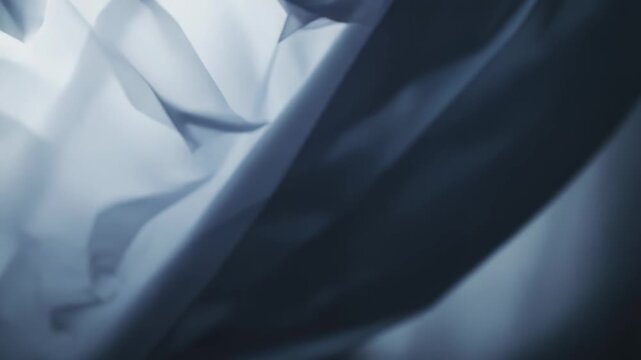 Translucent crinkled film texture with layered, wrinkled material creating an abstract, airy background of soft light, shadow and delicate flowing forms