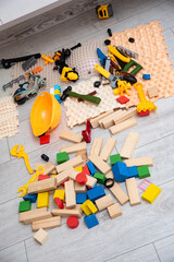 Fototapeta premium Mixed wooden blocks builder toys and orthopedic mats on floor in kids room