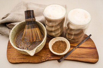 Preparing matcha tea lattes with bamboo whisk