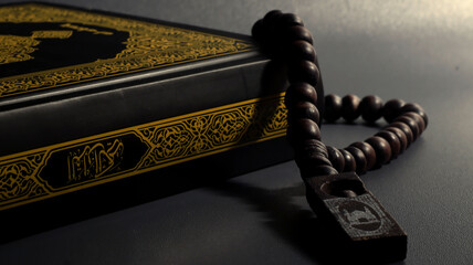 Sacred Text and Prayer Beads: A close-up shot captures the profound spirituality of a religious text, adorned with intricate gold patterns, lying beside a string of prayer beads.