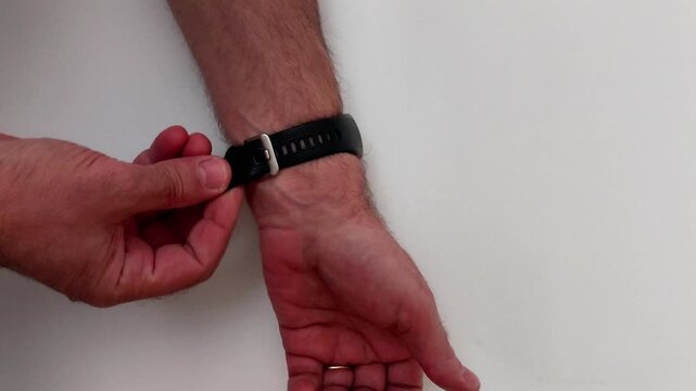 Secure a sleek black leather strap on your left wrist. This quick guide shows how to thread the buckle and tuck the end for a perfect, stylish fit every time