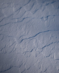 Fototapeta premium Snowy patterns on surface of ground during winter