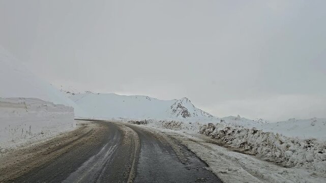 Enjoying a drive along a winding snow-covered mountain road with high snow walls, snowy hills, rugged peaks, and an overcast sky in a remote winter landscape.
📍Hawraman Takht, Kurdistan 