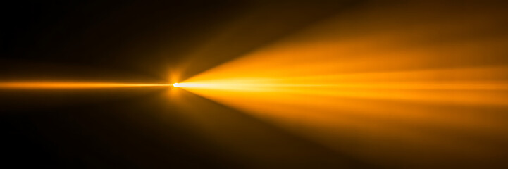 Fototapeta premium Bright Orange Lens Flare Effect - Dynamic Light Rays on Dark Background for Overlay or Abstract Design