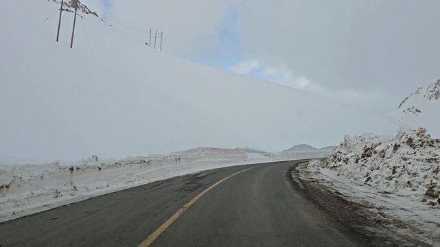 Enjoying a drive along a winding snow-covered mountain road with high snow walls, snowy hills, rugged peaks, and an overcast sky in a remote winter landscape.
📍Hawraman Takht, Kurdistan 