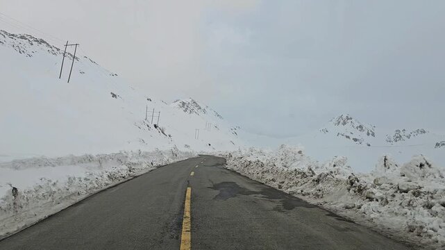 Enjoying a drive along a winding snow-covered mountain road with high snow walls, snowy hills, rugged peaks, and an overcast sky in a remote winter landscape.
📍Hawraman Takht, Kurdistan 