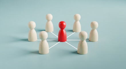 Obraz premium Red wooden figure surrounded by white wooden figures on a blue background, representing leadership and teamwork concepts in a minimalist design