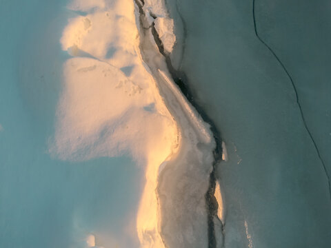 Frozen lake edge in Michigan captured from a drone at sunset