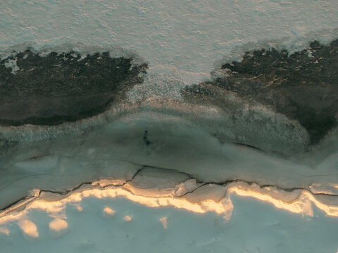 Winter drone view of frozen ice layers and patterns in Michigan