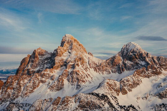 Snow covered alpine peaks glowing in warm evening light.