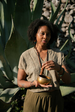 Black Woman Leading Wellness Ritual with Singing Bowl in Mexico