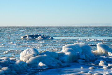Frozen Baltic Sea Coastline with Ice Formations and Winter Horizon Under Clear Blue Sky © Zigmunds