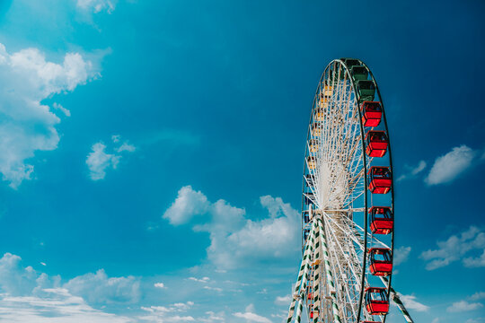 Side View of Ferris Wheel in front of Blue Sky