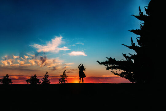 Silhouette of Girl Dancing in Sunset