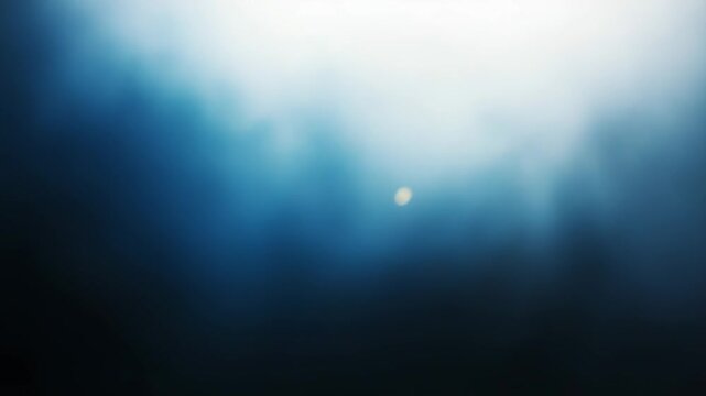 Ethereal blue light permeates through soft, swirling mist and dramatic clouds, creating an abstract and atmospheric background, conveying concepts of tranquility and mystery