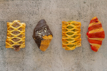 Top view flat lay of Assorted fresh bakery pastries and cookies arranged on a rustic wooden table