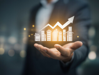 real estate concept -man holds glowing houses and arrow in his palm